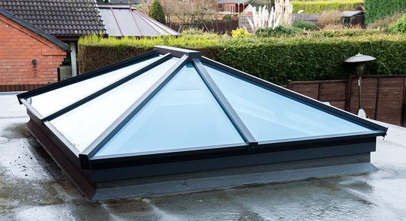 Bespoke rectangular roof lantern sits centerally in this orangery extension