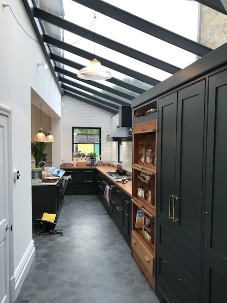 Bespoke rectangular roof lantern sits above a dining area.