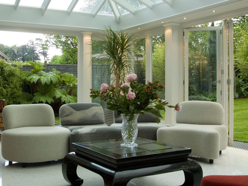 Soft seating and a table and chairs in an orangery extension