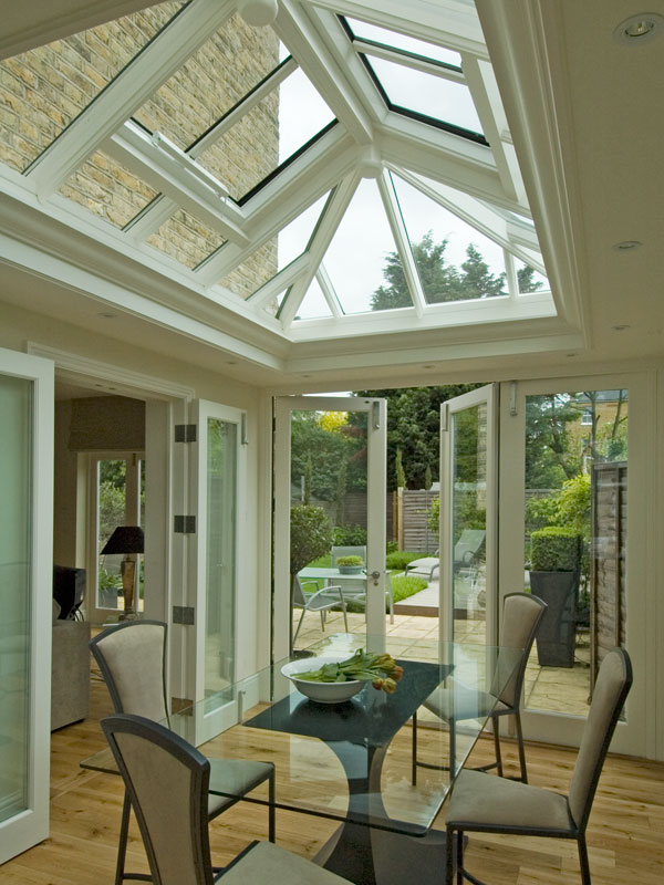 A roof lantern perfectly defines a dining area in an elegant orangery in London